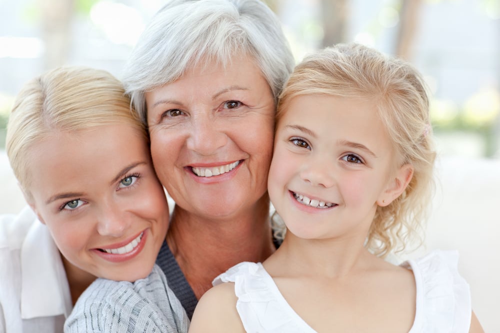 Portrait of a joyful family looking at the camera at home